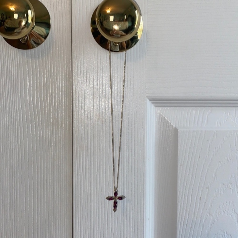 Beautiful Cross necklace with maroon gems and a gold(not real gold) chain.